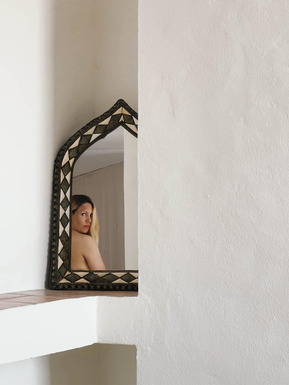 photograph of a girl reflected in a mirror
