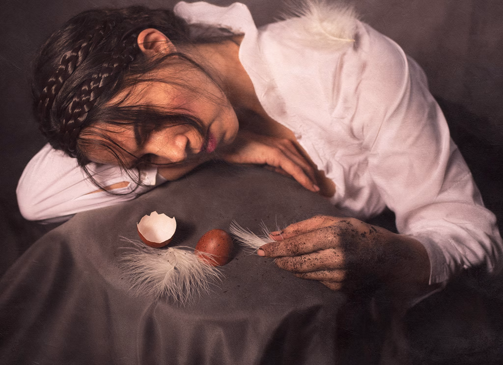 fine art self portrait photograph of woman with eggs and feathers