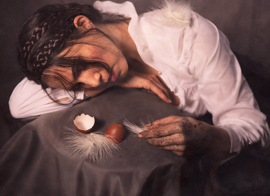 fine art self portrait photograph of woman with eggs and feathers