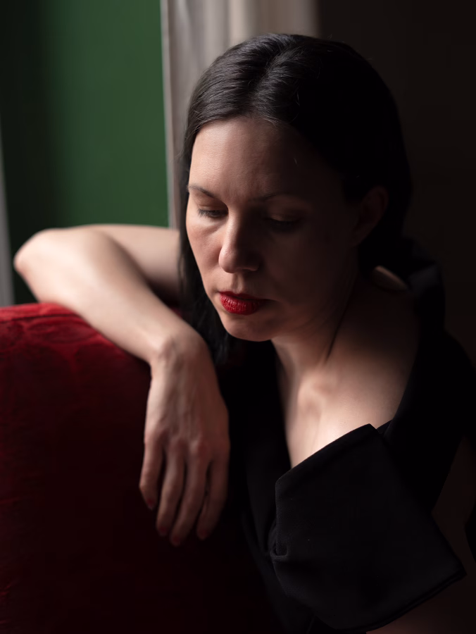 Cinematic photograph of woman in a red chair