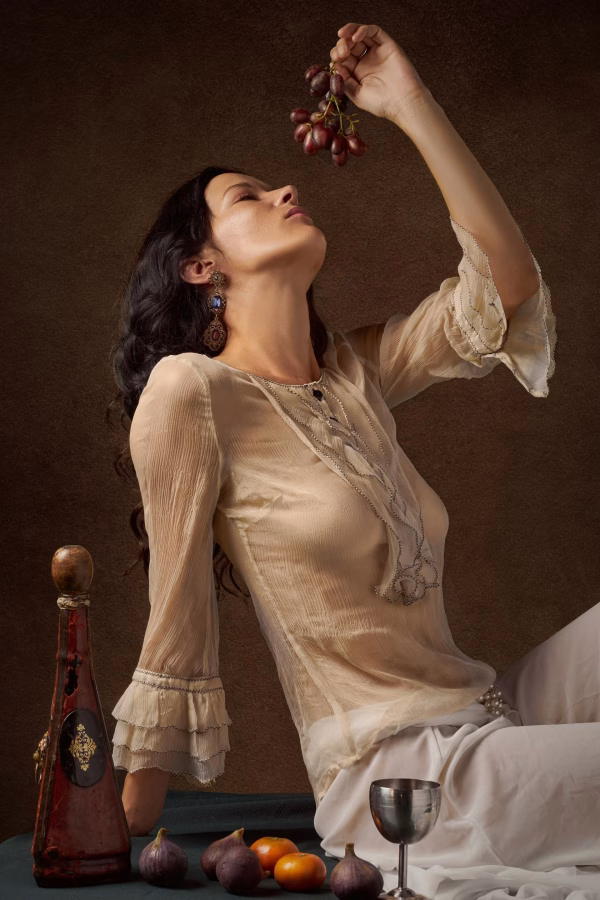 fine art photograph of woman with grapes