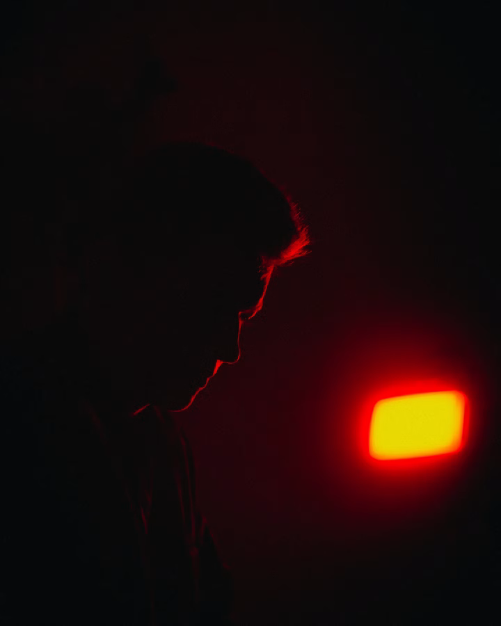 photograph of man with red light