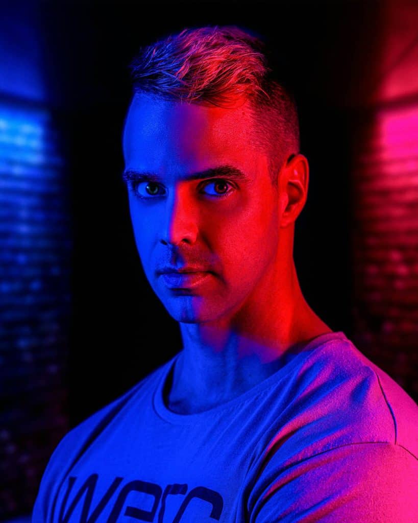 cinematic photography photo of a man with two tone coloured lighting